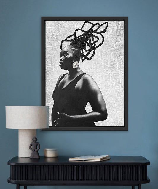 Framed black and white portrait of an African American woman with unique hair braids on a blue wall above a dark wooden console table.